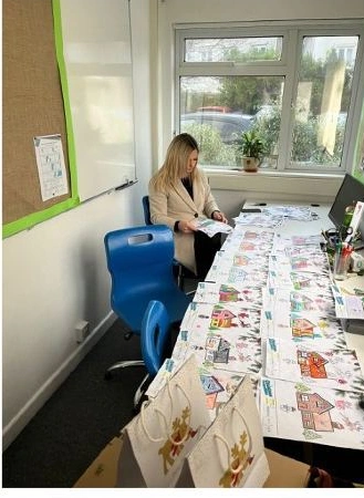 Poltair community engagement team reviewing children’s colouring entries