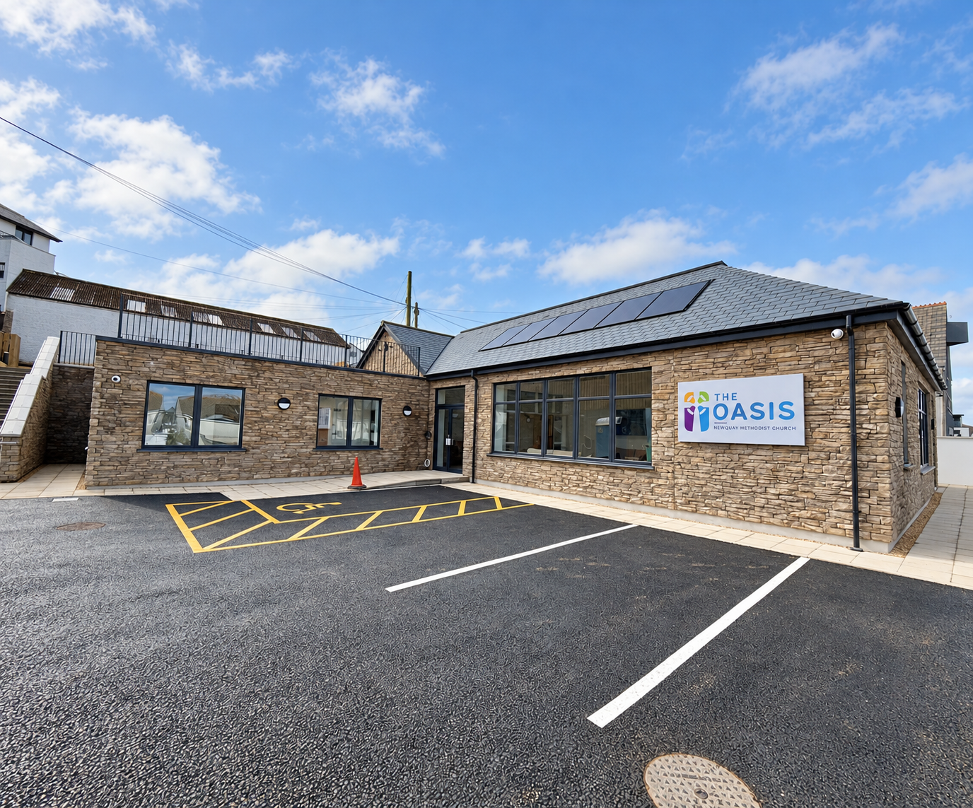 Newquay Methodist Church and community building under a blue sky